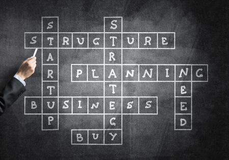 Studying concept with crossword drawn with chalk on blackboardの写真素材