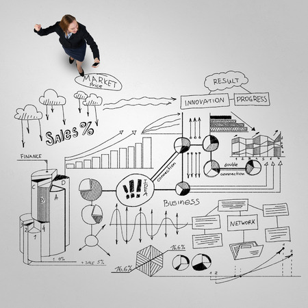 Top view of businesswoman and business strategy sketches on floorの写真素材