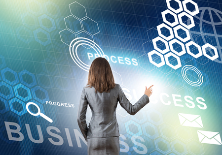 Back view of businesswoman working with digital virtual panelの写真素材