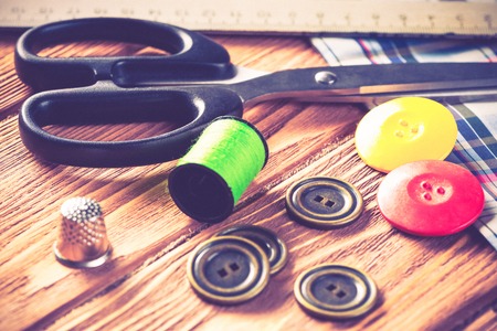 Bright image of sewing kit accessories on wooden tableの写真素材