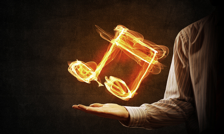 Close up of person hand holding fire music symbolの写真素材