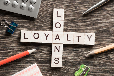 Business workplace with loyalty loans words on tableの写真素材