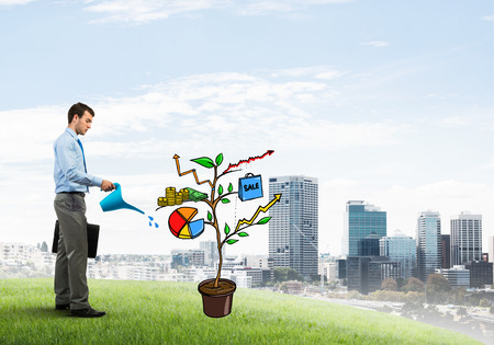 Handsome businessman presenting investment and financial growth conceptの写真素材
