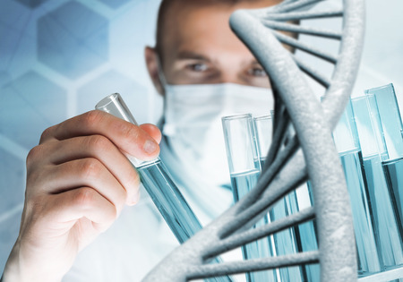 Handsome scientist making research over dna molecule structureの写真素材