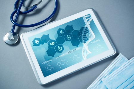 White tablet pc and doctor tools on gray surfaceの写真素材