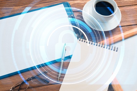 Tablet, coffee cup and other office stuff on wooden tableの写真素材