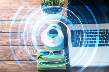 Opened laptop and other office stuff on wooden tableの写真素材