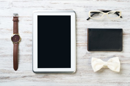 Men's accessories and tablet on white wooden surfaceの写真素材