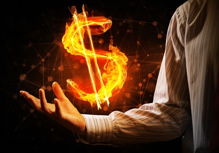 Close of businessman hand showing in palm glowing dollar signの写真素材