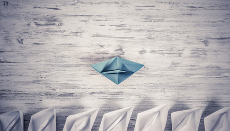 Set of origami boats on wooden tableの写真素材