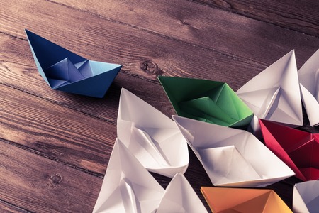 Business leadership concept with white and color paper boats onの写真素材