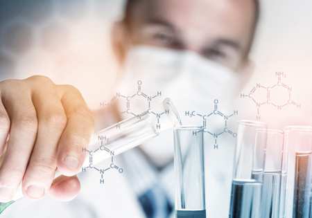 Portrait of concentrated male scientist working with reagents in laboratoryの写真素材