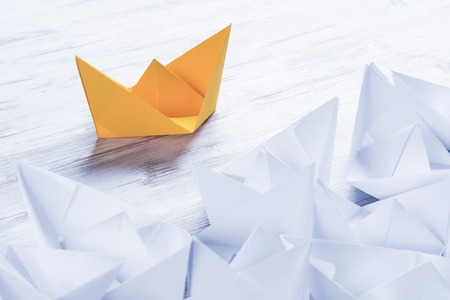Business leadership concept with white and color paper boats onの写真素材
