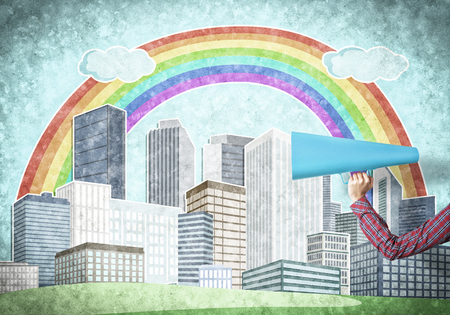 Hand of woman holding blue paper trumpet against illustrated backgroundの写真素材