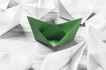 Business leadership concept with white and color paper boats onの写真素材
