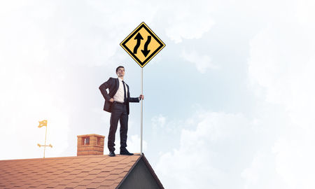 Mister boss on brick roof with sign in hands. Mixed mediaの写真素材
