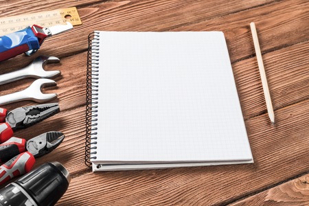 Variety of repair tools on wooden surface and place for textの写真素材