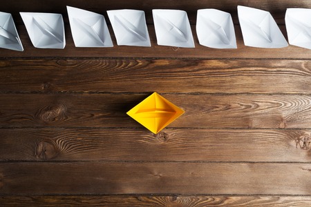 Set of origami boats on wooden tableの写真素材