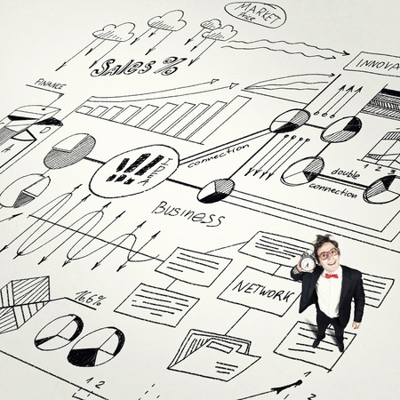 Young businessman holding old alarm clock on sketch backgroundの写真素材