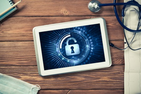 Doctors workplace with white tablet stethoscope and maskの写真素材