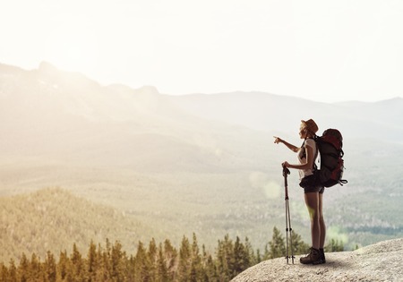 Young woman hiker walking in beautiful mountain nature landscapeの写真素材