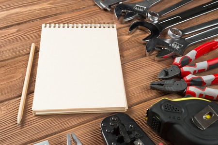 Variety of repair tools on wooden surface and place for textの写真素材