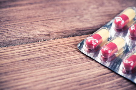 Pills on grunge wooden table. Medicine and drugstore conceptの写真素材