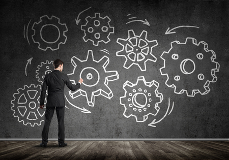 Businessman standing with back and drawing concept of teamwork and cooperationの写真素材