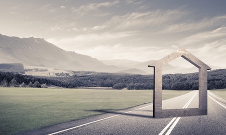 House stone figure as symbol of real estate outdoors against natural landscapeの写真素材