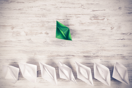 Set of origami boats on wooden tableの写真素材