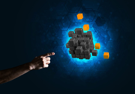 Close of man hand holding cube figure as symbol of innovation. Mixed media