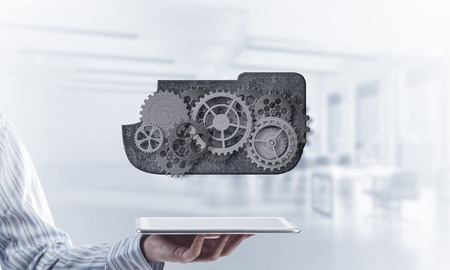 Metal gears and cogwheels mechanism or engine on white office background. Mixed mediaの写真素材