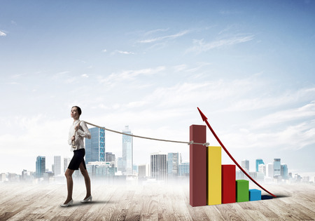 Young woman outdoors and growing graph presenting growth progressの写真素材