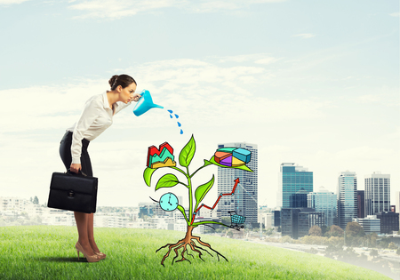 Attractive businesswoman presenting investment and financial growth conceptの写真素材