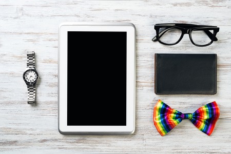 Mens accessories and tablet on white wooden surfaceの写真素材