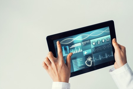 Tablet pc device with medicine interface screen in hands of doctorの写真素材