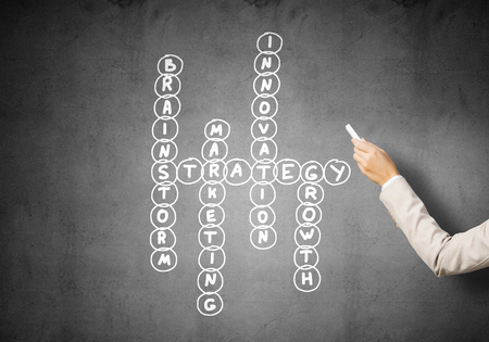 Business concept with crossword drawn on blackboardの写真素材