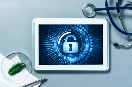 Doctors workplace with white tablet stethoscope and maskの写真素材