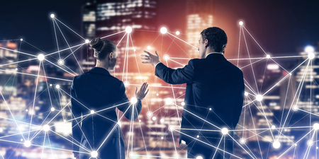 Businessman and businesswoman standing with back and touching connection conceptの写真素材