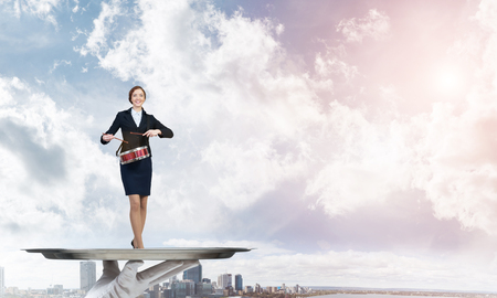 Hand of waiter presenting on tray woman playing drumsの写真素材