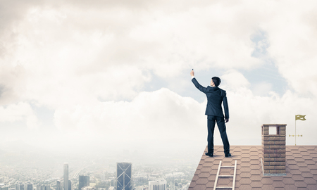 Young man standing with back with marker. Mixed mediaの写真素材