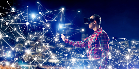 Young man with virtual reality headset or 3d glasses among connection linesの写真素材