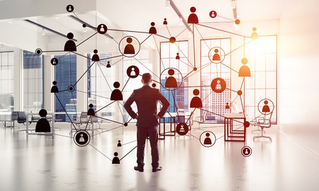 Elegant businessman in 3D office interior and social connection concept. Mixed mediaの写真素材