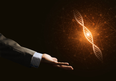 Close of businessman hand presenting DNA molecule research as concept. Mixed mediaの写真素材