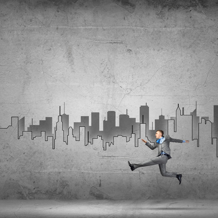 Young businessman in room running in a hurryの写真素材
