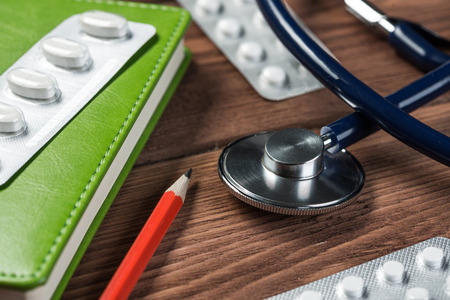 Close view of stethoscope on wooden deskの写真素材