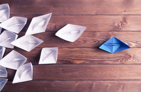 Set of origami boats on wooden tableの写真素材