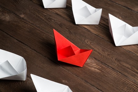 Set of origami boats on wooden tableの写真素材