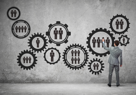 Businessman standing with back and drawing concept of teamwork and cooperationの写真素材