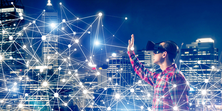 Young man with virtual reality headset or 3d glasses among connection linesの写真素材